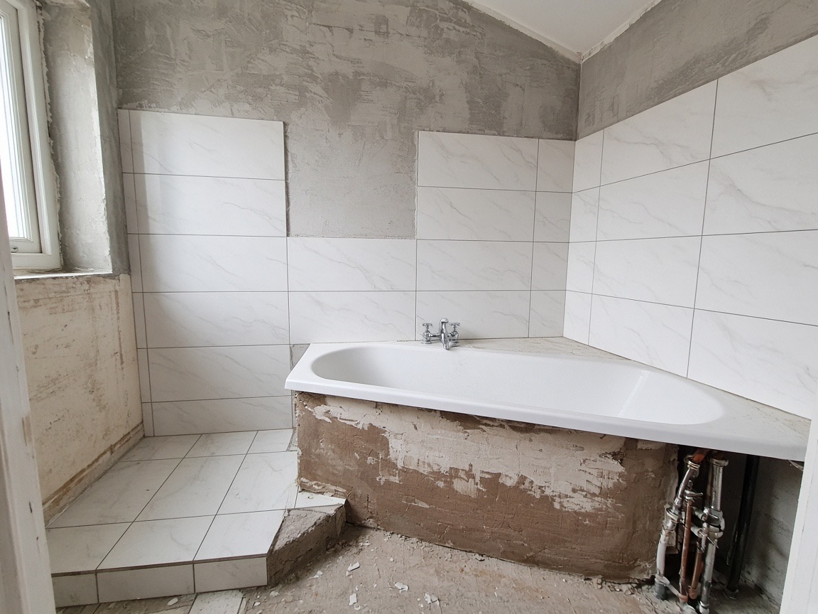 Bathroom tiling and plumbing in progress